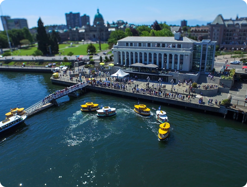 a boat on a body of water with a city in the background