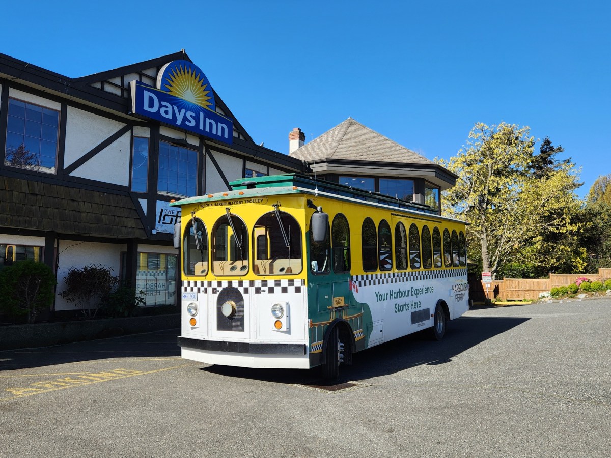 Vintage Victoria Harbour Ferry trolley parked outside a Days Inn hotel.